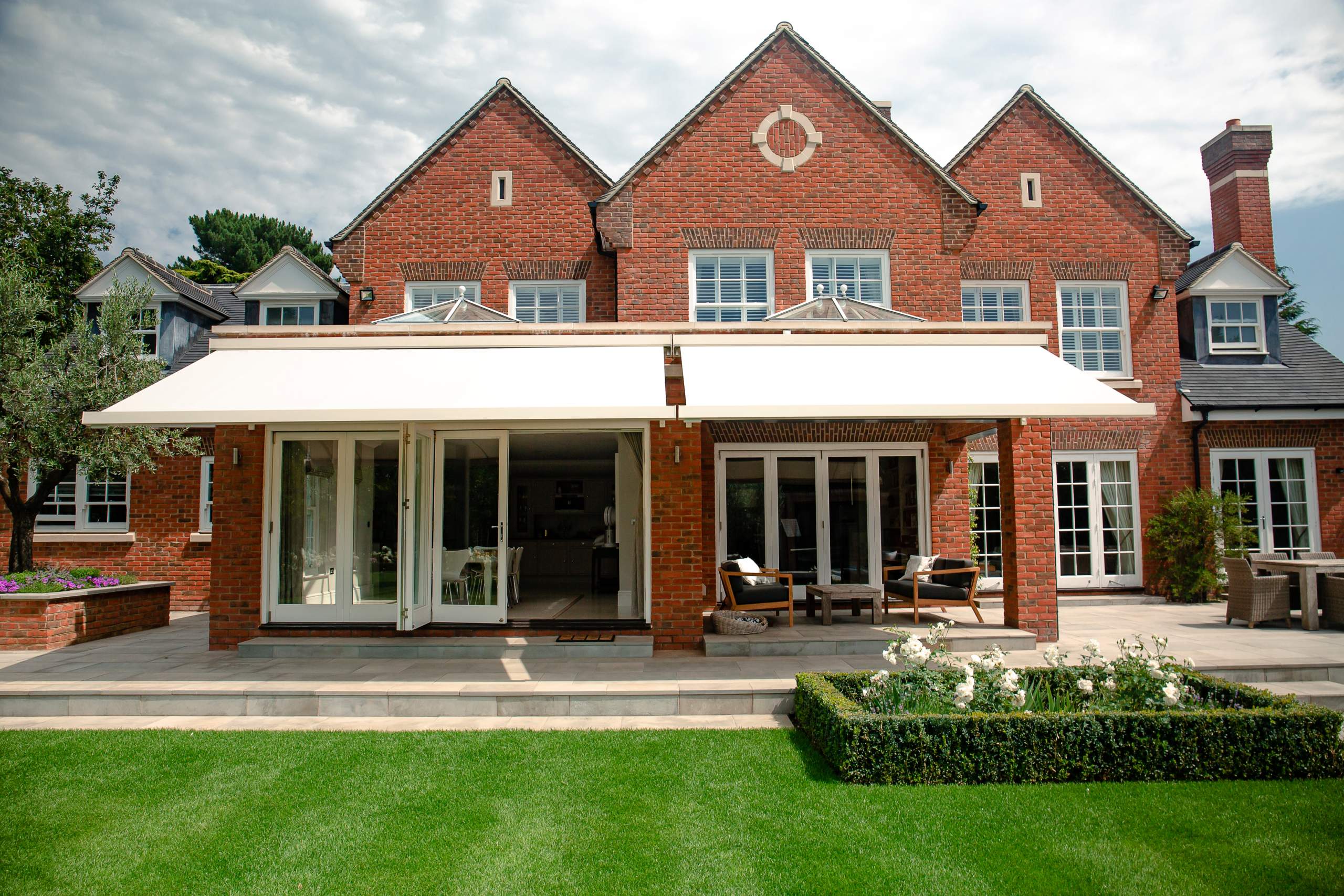 Patio awning attached to a red brick house