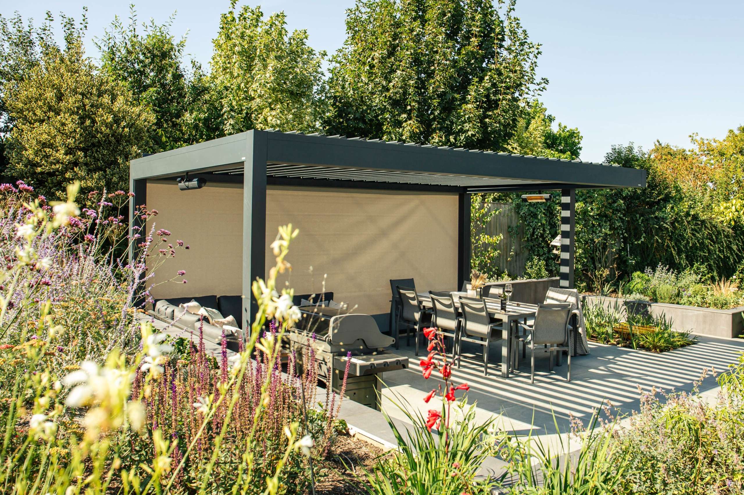 Louvered pergola in a picturesque garden on a sunny day