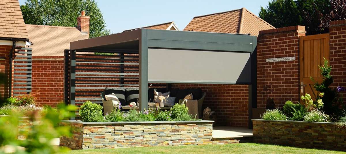 Louvered pergola with a side screen. Sunny day in a garden setting.